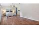Spacious main bedroom with wood floors, a ceiling fan, and a comfortable king-sized bed at 6702 Towhe Dr, Seffner, FL 33584
