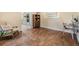 Bright office space with hardwood floors and a view into a modern kitchen at 6702 Towhe Dr, Seffner, FL 33584