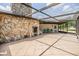 Expansive screened-in patio with an outdoor grill and stone accent wall, perfect for entertaining guests at 6702 Towhe Dr, Seffner, FL 33584