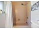Shower and tub combination featuring unique tile surround, a seat and decor at 6702 Towhe Dr, Seffner, FL 33584