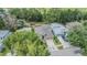 Aerial view of a well-manicured home featuring lush landscaping and a private backyard at 7815 Blue Spring Dr, Land O Lakes, FL 34637
