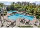 A captivating view of the community pool area with palm trees and ample lounging space at 7815 Blue Spring Dr, Land O Lakes, FL 34637