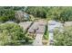 Aerial view of a home with well-maintained landscaping, a private backyard, and a paved driveway at 7815 Blue Spring Dr, Land O Lakes, FL 34637