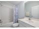 Clean bathroom featuring a shower over tub with shower curtain, sink, and mirror at 7815 Blue Spring Dr, Land O Lakes, FL 34637