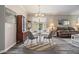 Formal dining room, hardwood floors, white table and gray chairs, mirror and lots of natural light at 7815 Blue Spring Dr, Land O Lakes, FL 34637