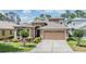Charming two-story home with a well-maintained lawn and two car garage at 7815 Blue Spring Dr, Land O Lakes, FL 34637