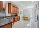 Eat-in kitchen featuring wooden cabinets, tile floors, and dining table at 7815 Blue Spring Dr, Land O Lakes, FL 34637
