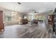 Spacious living room with gray floors, plush sofas, view to outdoor living, and lots of natural light at 7815 Blue Spring Dr, Land O Lakes, FL 34637