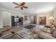 Inviting living room featuring hardwood floors, a ceiling fan, and comfortable couches in a relaxing space at 7815 Blue Spring Dr, Land O Lakes, FL 34637