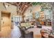 Inviting lobby with a vaulted ceiling, nature-themed decor, comfortable wicker furniture, and wood-look tile floors at 7815 Blue Spring Dr, Land O Lakes, FL 34637