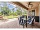 Enjoyable screened patio with brick flooring and a table set for outdoor dining at 7815 Blue Spring Dr, Land O Lakes, FL 34637