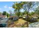Backyard view features detached garages, fenced yard, and mature trees at 905 E Hanna Ave, Tampa, FL 33604