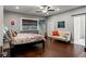 Spacious bedroom with hardwood floors, seating, and natural light from windows and sliding glass doors at 905 E Hanna Ave, Tampa, FL 33604