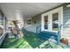 Covered porch with decorative floor and outdoor seating, providing an entertainment space at 905 E Hanna Ave, Tampa, FL 33604