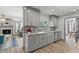 Stylish kitchen with sleek gray cabinetry, marble countertops, and stainless steel appliances at 914 Woodland Dr, Palm Harbor, FL 34683