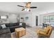 Comfortable living room with a plush sectional, stylish decor, and an adjacent dining area at 914 Woodland Dr, Palm Harbor, FL 34683