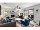 Cozy living room with fireplace, ceiling fan, and sliding doors that open to the screened-in pool area at 914 Woodland Dr, Palm Harbor, FL 34683