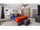 Spacious main bedroom with fan, gray walls, and a wall decorated with multiple art pieces at 914 Woodland Dr, Palm Harbor, FL 34683