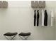 A well-organized closet space with ample storage and stylish stools at 9384 Gladsome Dr, Land O Lakes, FL 34637