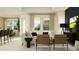 Open concept living room with stylish seating, large windows, and smooth transition to the bar and dining areas at 9384 Gladsome Dr, Land O Lakes, FL 34637