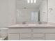 Bathroom featuring a dual sink vanity, white cabinets, and modern fixtures at 9766 Crescent Moon Dr, Riverview, FL 33578