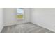 Bright bedroom featuring a large window, new carpet, and neutral walls at 9766 Crescent Moon Dr, Riverview, FL 33578