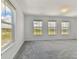 Bedroom with a large window offering beautiful views and allowing natural light at 9766 Crescent Moon Dr, Riverview, FL 33578