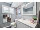 Stylish bathroom with modern vanity, decorative mirrors, and blue accent wall at 10115 Kenlake Dr, Riverview, FL 33578