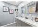 Bright bathroom with double vanity, updated fixtures, and decorative accents at 10115 Kenlake Dr, Riverview, FL 33578