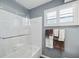 Clean bathroom with white tiled shower, modern fixtures, and stylish towel rack at 10115 Kenlake Dr, Riverview, FL 33578