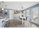 Bright dining area with white table set, modern lighting, and access to outdoor views at 10115 Kenlake Dr, Riverview, FL 33578
