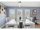 Elegant dining area featuring shuttered windows, white decor, and modern lighting at 10115 Kenlake Dr, Riverview, FL 33578