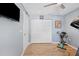The exercise room has wood-look floors, a white door, and a large white closet with an exercise bike nearby at 10115 Kenlake Dr, Riverview, FL 33578