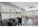 This Florida room has a black and white tile floor, lots of light, and stylish seating, perfect for entertaining at 10115 Kenlake Dr, Riverview, FL 33578