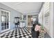 The Florida room has black and white tile flooring, a sliding glass door, and a popcorn machine for fun gatherings at 10115 Kenlake Dr, Riverview, FL 33578
