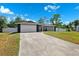 Wide driveway leading to a single-story home with an attached two-car garage at 10115 Kenlake Dr, Riverview, FL 33578