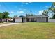 Daytime view of a single-story home featuring a two-car garage and a spacious front yard at 10115 Kenlake Dr, Riverview, FL 33578