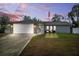 Charming single-story home with a well-manicured lawn and an American flag at 10115 Kenlake Dr, Riverview, FL 33578
