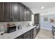 Modern kitchen features granite counters, stainless steel appliances, and gray cabinets at 10115 Kenlake Dr, Riverview, FL 33578