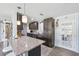 Stylish kitchen with granite countertops, dark cabinetry, and stainless steel appliances at 10115 Kenlake Dr, Riverview, FL 33578