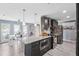 Open concept kitchen with granite island, stainless appliances, and access to dining area at 10115 Kenlake Dr, Riverview, FL 33578
