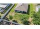 Aerial view of the fenced backyard with green lawn, mature trees, and patio at 10463 Baylor Dr, Spring Hill, FL 34608