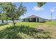 Spacious backyard with a well-maintained lawn, a screened porch, and a privacy fence at 10463 Baylor Dr, Spring Hill, FL 34608