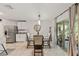 Cozy dining area with a modern table, seating for four, and a view of the back patio at 10463 Baylor Dr, Spring Hill, FL 34608