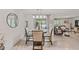 Bright dining area with a round table, four chairs, and a view into the living room at 10463 Baylor Dr, Spring Hill, FL 34608