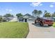 Inviting single-Gathering home featuring a well-manicured lawn and a long driveway at 10463 Baylor Dr, Spring Hill, FL 34608