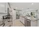 Modern kitchen with stainless steel appliances, white cabinets, and granite countertops at 10463 Baylor Dr, Spring Hill, FL 34608