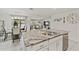 Open-concept kitchen with granite countertops, a kitchen island, and stainless steel appliances at 10463 Baylor Dr, Spring Hill, FL 34608