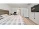 Bright bedroom featuring a television and a walk-in closet at 10463 Baylor Dr, Spring Hill, FL 34608