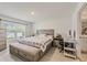 Bright bedroom features a large window, desk, and modern furnishings at 10463 Baylor Dr, Spring Hill, FL 34608